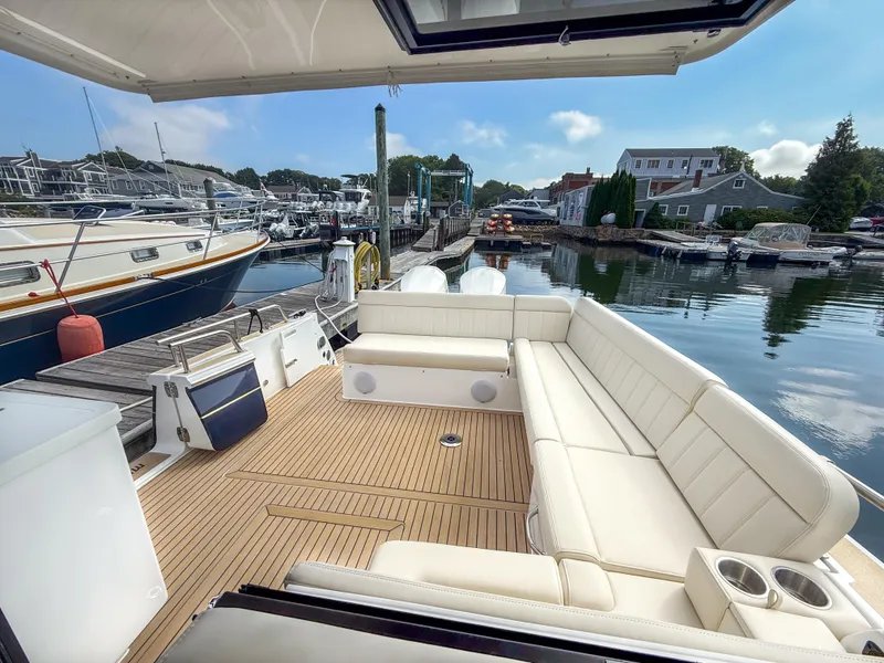 Slide: The Image of Luxurious 2026 MJM 47R yacht with spacious seating at a marina dock. - 21