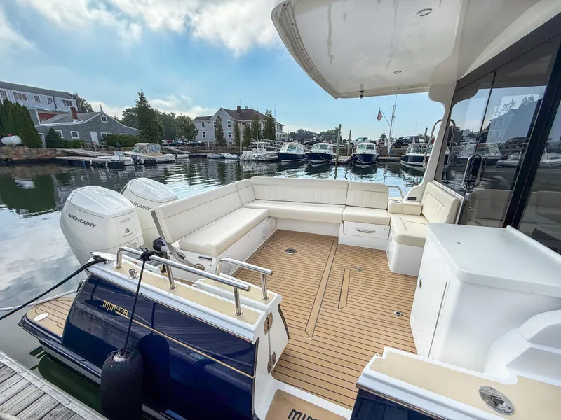 Slide: The Image of Luxury MJM 47R 2026 yacht with spacious deck and seating, docked in a serene marina. - 22