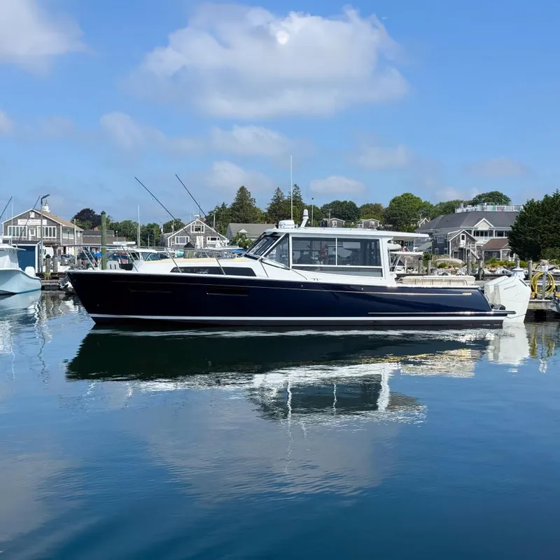Slide: The Image of 2026 MJM 47R yacht docked in a serene marina, reflecting on calm water. - 26