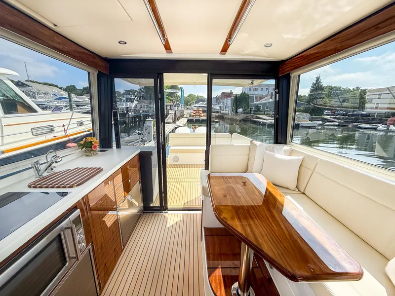 Slide: The Image of Luxurious interior of 2026 MJM 47R yacht with modern kitchen and seating area. - 5