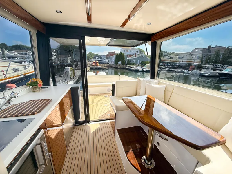 Slide: The Image of Luxurious interior of 2026 MJM 47R yacht with elegant seating and wooden table. - 9