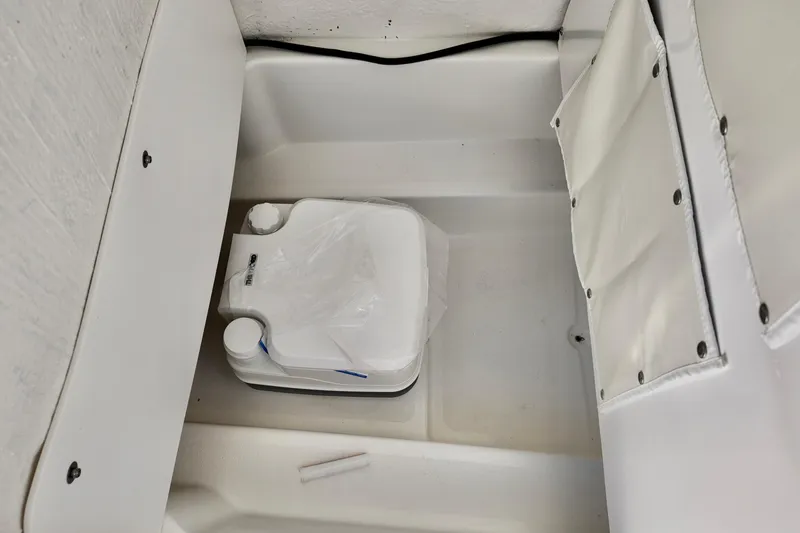 Slide: The Image of Portable toilet in the 2026 NauticStar 212 Legacy boat interior. - 13
