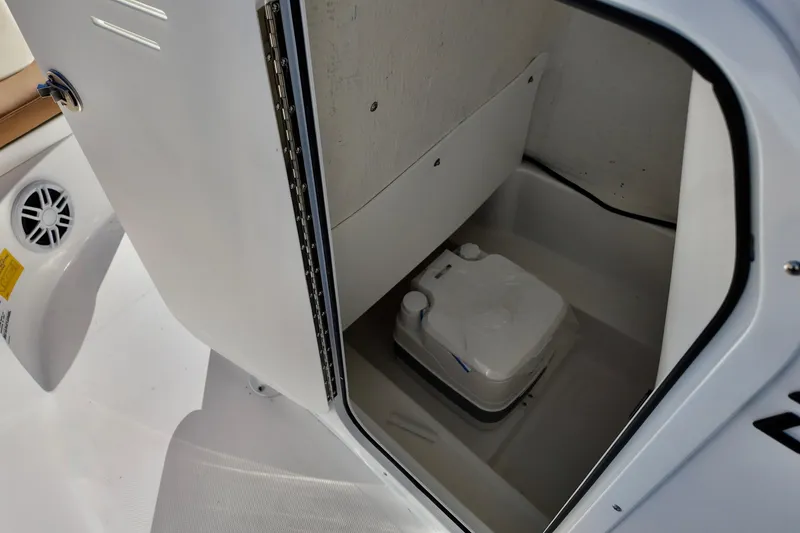 Slide: The Image of 2026 NauticStar 212 Legacy boat interior with compact marine toilet. - 14