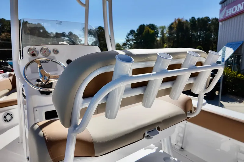 Slide: The Image of 2026 NauticStar 212 Legacy boat interior with rod holders and steering console. - 16
