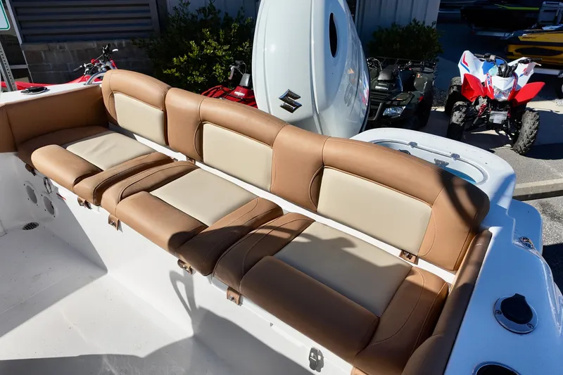 Slide: The Image of 2026 NauticStar 212 Legacy boat with tan and cream seating, outdoor display. - 18