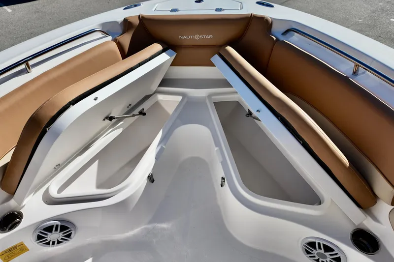 Slide: The Image of 2026 NauticStar 212 Legacy boat interior with open storage compartments and cushioned seating. - 21
