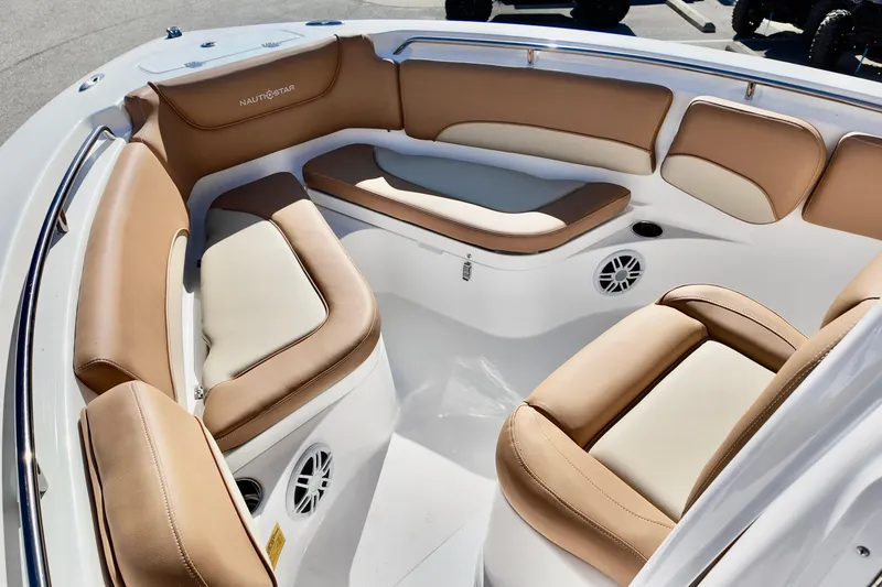 Slide: The Image of 2026 NauticStar 212 Legacy boat interior with tan and white cushioned seating. - 22