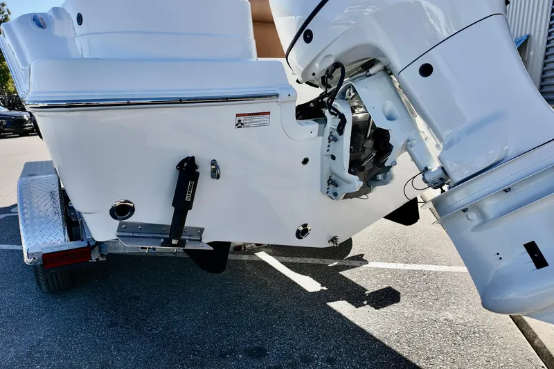 Slide: The Image of 2026 NauticStar 212 Legacy boat's outboard motor and trailer detail. - 23