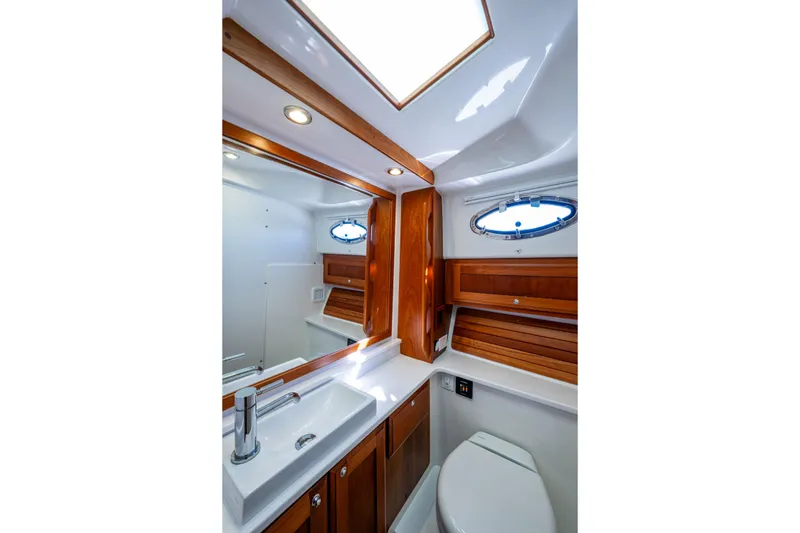 Slide: The Image of Luxurious bathroom in 2020 Back Cove 340 yacht with wood accents and modern fixtures. - 11