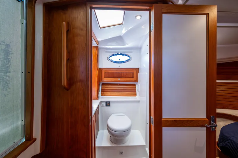 Slide: The Image of 2020 Back Cove 340 yacht bathroom with wooden accents and modern fixtures. - 13
