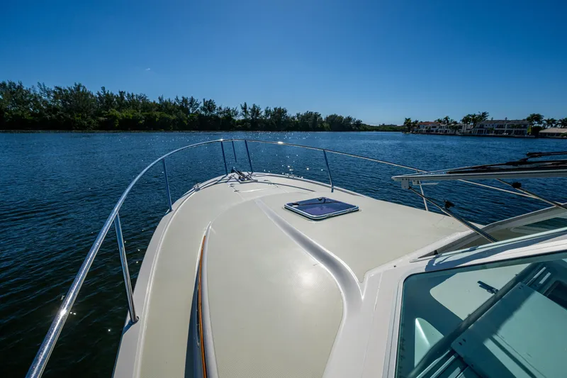 Slide: The Image of Bow view of 2020 Back Cove 340 boat on a sunny day, cruising on calm waters. - 2