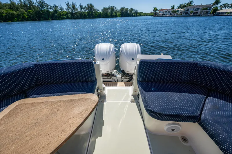 Slide: The Image of 2020 Back Cove 340 boat interior with seating and twin engines on a sunny day. - 24