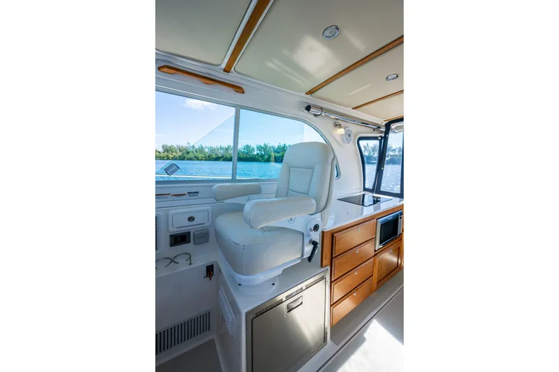 Slide: The Image of Interior of 2020 Back Cove 340 boat with helm seat and cabinetry. - 26