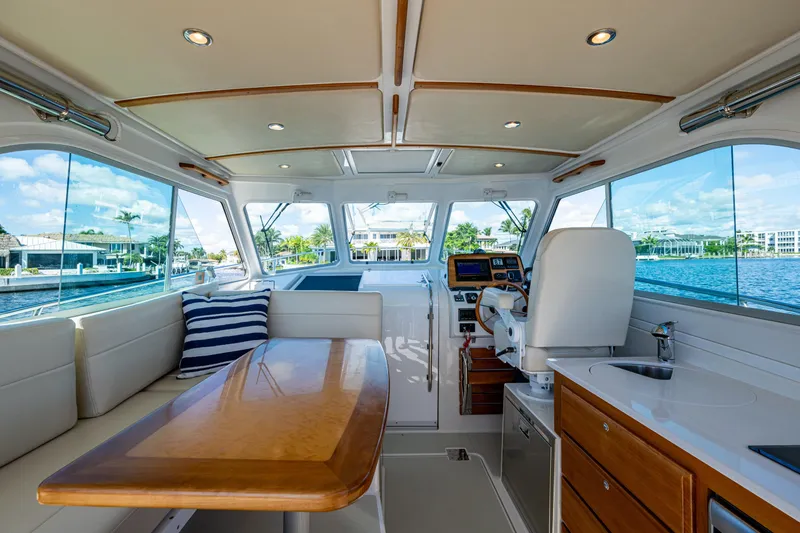 Slide: The Image of Interior of 2020 Back Cove 340 yacht with elegant seating and helm, overlooking waterfront. - 27