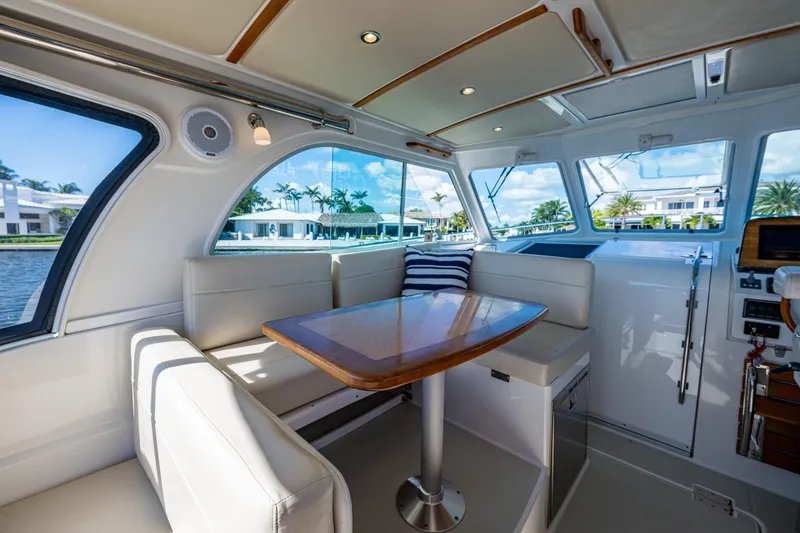 Slide: The Image of Interior of 2020 Back Cove 340 yacht with elegant seating and table, overlooking waterfront homes. - 28