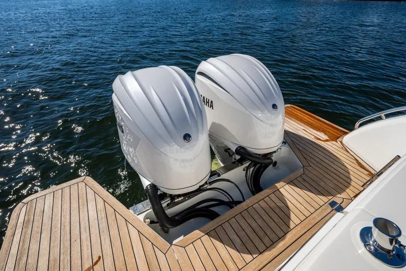 Slide: The Image of 2020 Back Cove 340 boat with twin Yamaha outboard engines on wooden deck. - 36