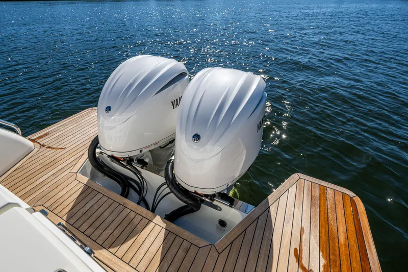 Slide: The Image of 2020 Back Cove 340 boat with twin Yamaha outboard engines on wooden deck. - 37