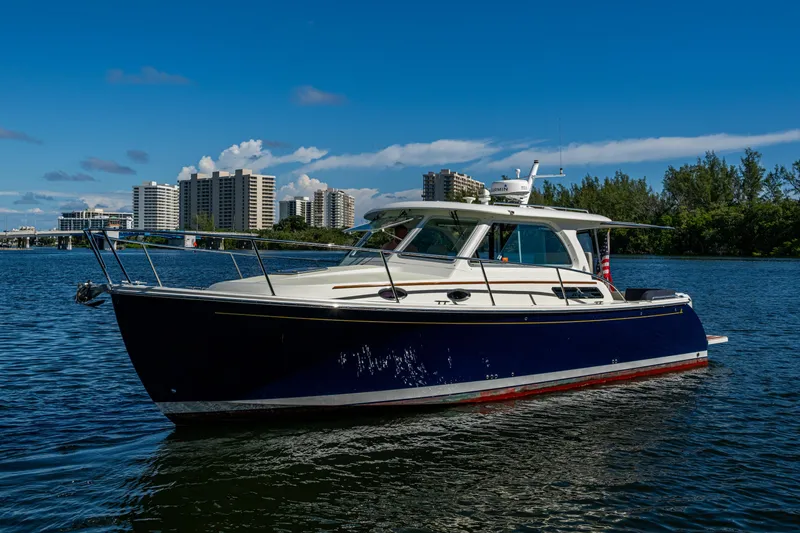 Slide: The Image of 2020 Back Cove 340 boat on water with cityscape background. - 38
