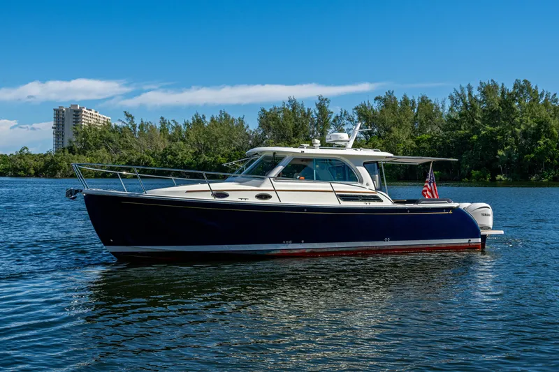 Slide: The Image of 2020 Back Cove 340 boat on calm water with scenic background. - 39
