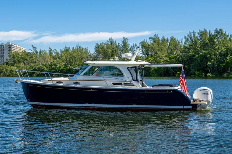 Slide: The Image of 2020 Back Cove 340 boat on water with American flag and Yamaha engine. - 41