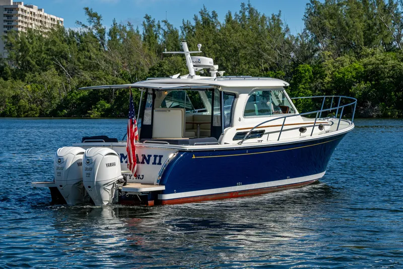 Slide: The Image of 2020 Back Cove 340 boat with twin Yamaha engines on a scenic waterway. - 43