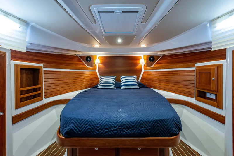 Slide: The Image of Luxurious cabin interior of 2020 Back Cove 340 yacht with wood paneling and cozy bedding. - 6