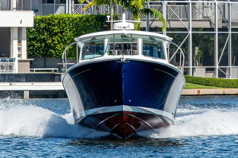 Slide: The Image of 2020 Back Cove 340 boat cruising on water, front view. - 64