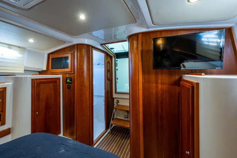Slide: The Image of Luxurious interior of 2020 Back Cove 340 yacht with wood paneling and mounted TV. - 9