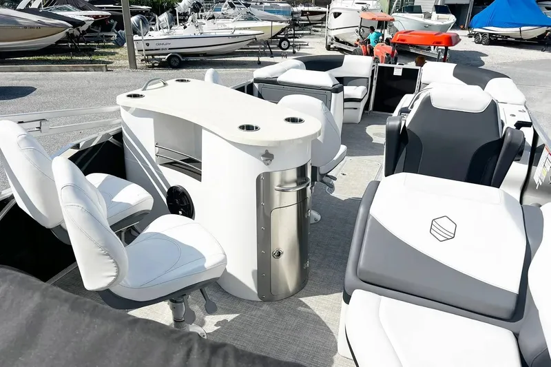 Slide: The Image of 2023 South Bay 523 R pontoon boat interior with seating and table setup. - 11