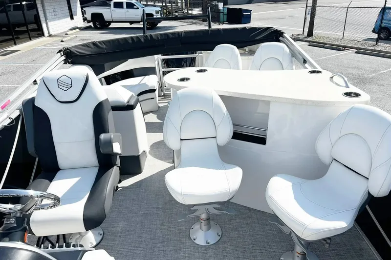 Slide: The Image of 2023 South Bay 523 R boat interior with white seating and steering wheel. - 12