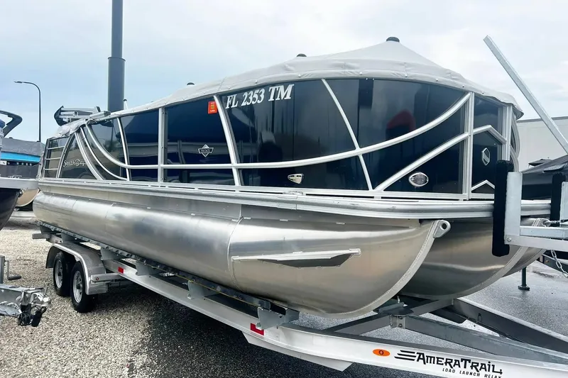 Slide: The Image of 2023 South Bay 523 R pontoon boat on trailer, sleek design, silver and black finish. - 3