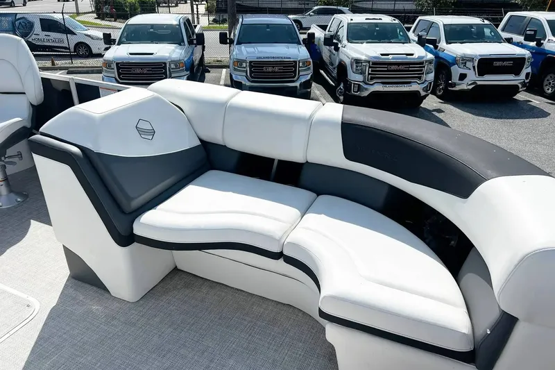 Slide: The Image of Luxury seating on 2023 South Bay 523 R boat, with parked GMC trucks in background. - 8