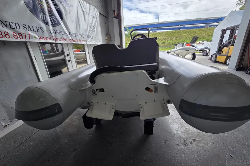 Slide: The Image of Northstar Vega 3.8 inflatable boat with Yamaha 30HP engine, displayed in a showroom. - 13