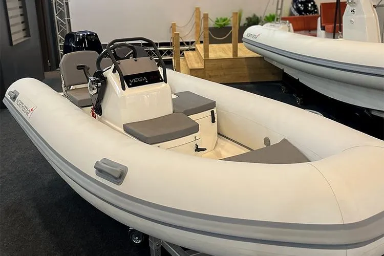 Slide: The Image of 2026 Northstar Vega 3.8 inflatable boat with Yamaha 30HP engine, top view. - 3