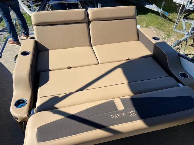 Slide: The Image of 2022 Barletta Cabrio C24UC boat with tan leather seating and cup holders. - 12