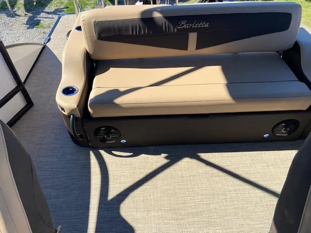 Slide: The Image of 2022 Barletta Cabrio C24UC boat interior with beige seating and cup holders. - 16