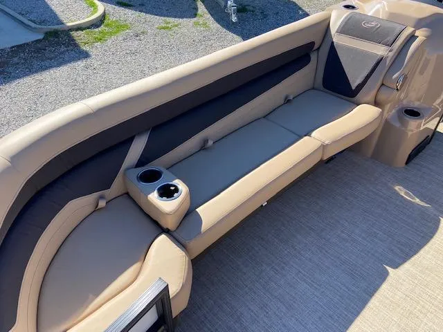 Slide: The Image of 2022 Barletta Cabrio C24UC boat interior with beige seating and cup holders. - 18