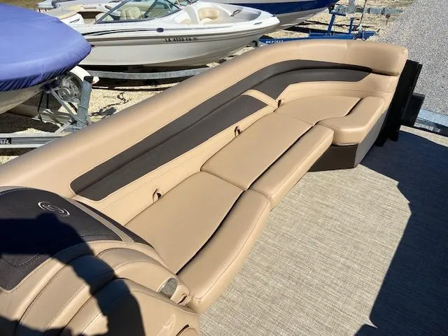 Slide: The Image of 2022 Barletta Cabrio C24UC boat interior with tan and black seating. - 19