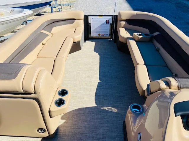 Slide: The Image of 2022 Barletta Cabrio C24UC boat interior with tan and brown seating. - 8