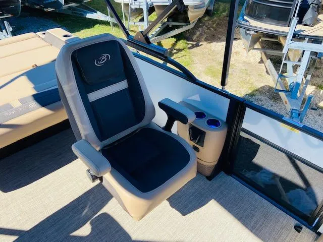 Slide: The Image of 2022 Barletta Cabrio C24UC boat captain's chair with armrests and cup holders. - 9
