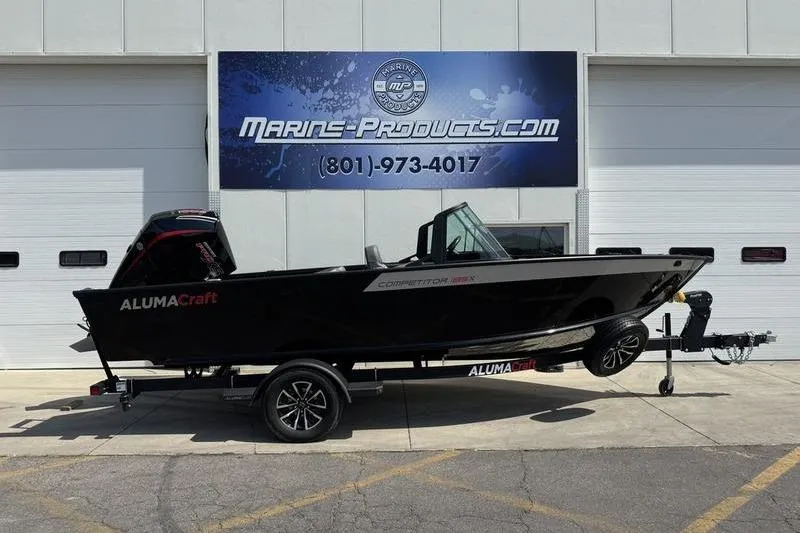 Slide: The Image of 2025 Alumacraft Competitor 185X Sport boat on trailer outside Marine-Products.com building. - 0