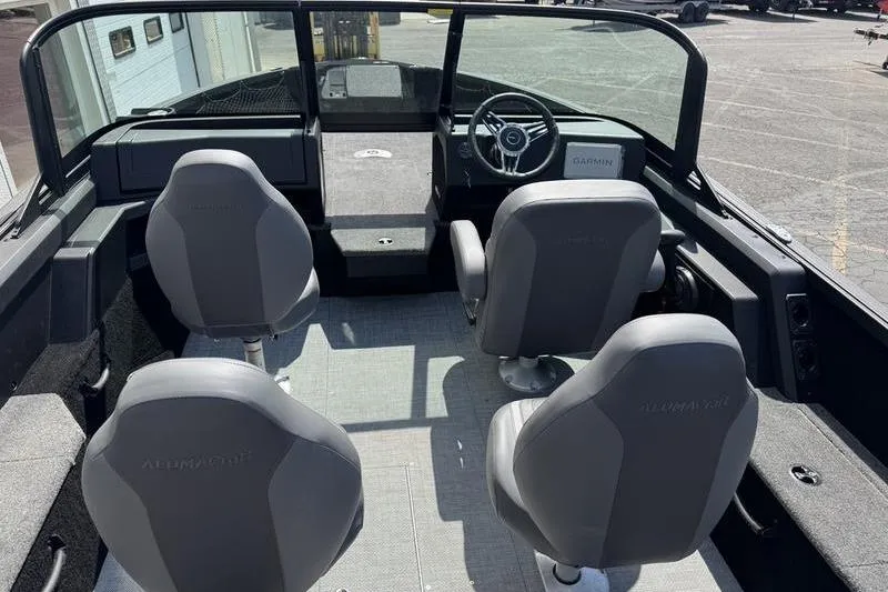 Slide: The Image of 2025 Alumacraft Competitor 185X Sport interior with four seats and steering console. - 5