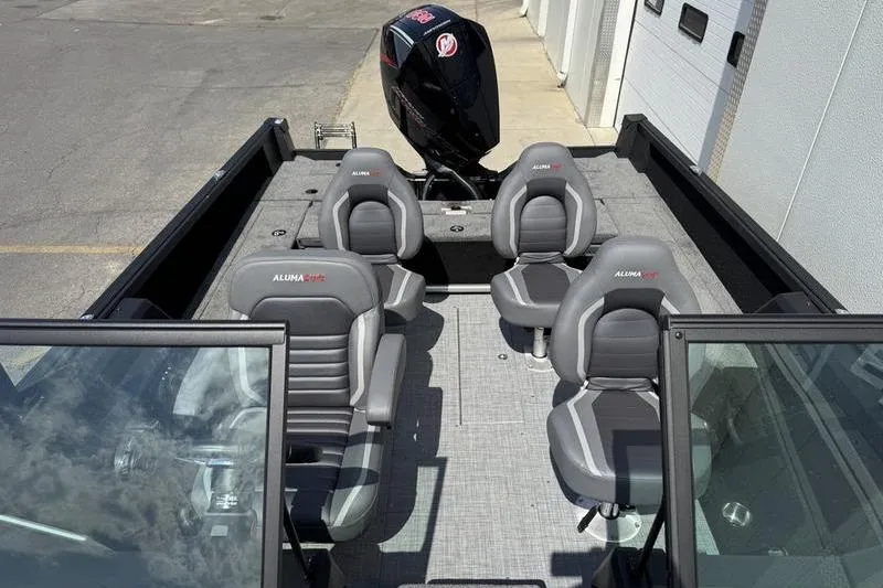 Slide: The Image of 2025 Alumacraft Competitor 185X Sport boat interior with four seats and outboard motor. - 6