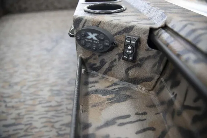 Slide: The Image of 2026 Xpress X18DB boat interior with camo design and control panel. - 13