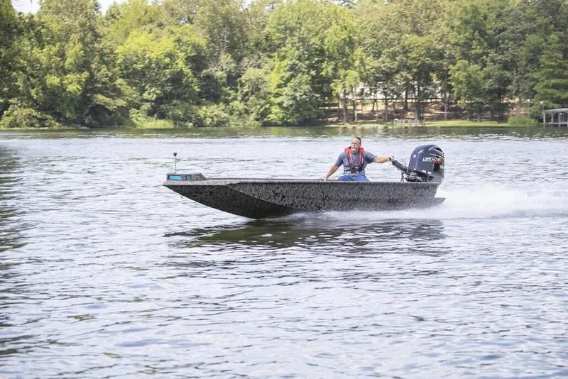 Slide: The Image of 2026 Xpress X18DB boat speeding on a lake with lush green trees in the background. - 7