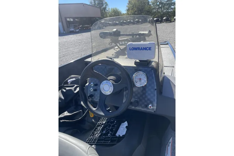 Slide: The Image of 2024 Bass Tracker Classic XL boat dashboard with steering wheel and Lowrance display. - 3