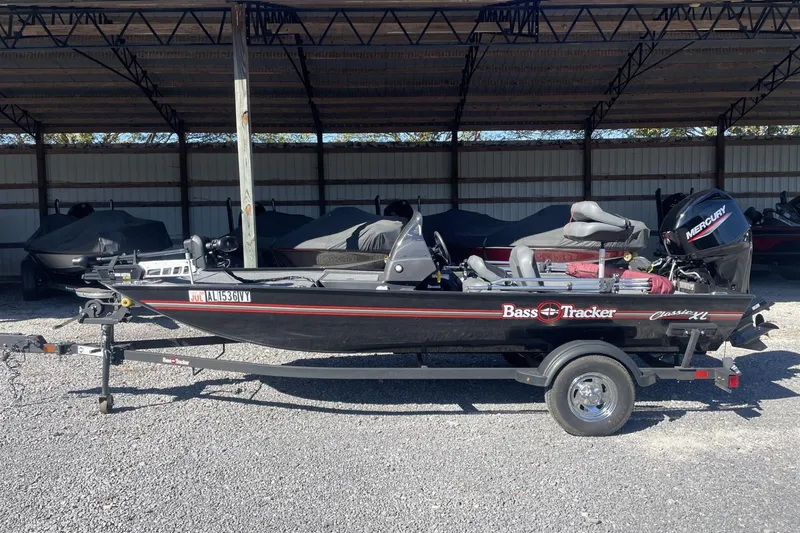 Slide: The Image of 2024 Bass Tracker Classic XL boat parked in a covered area. - 8