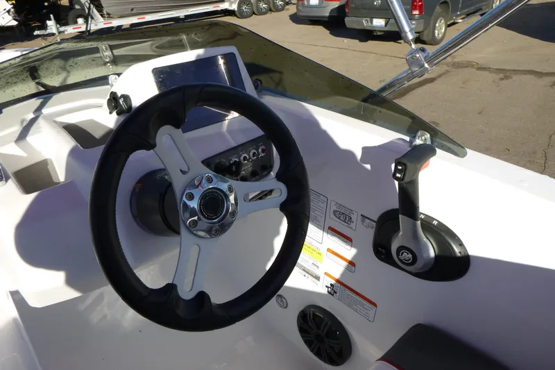 Slide: The Image of 2024 Tahoe T18 boat dashboard with steering wheel and control lever. - 11