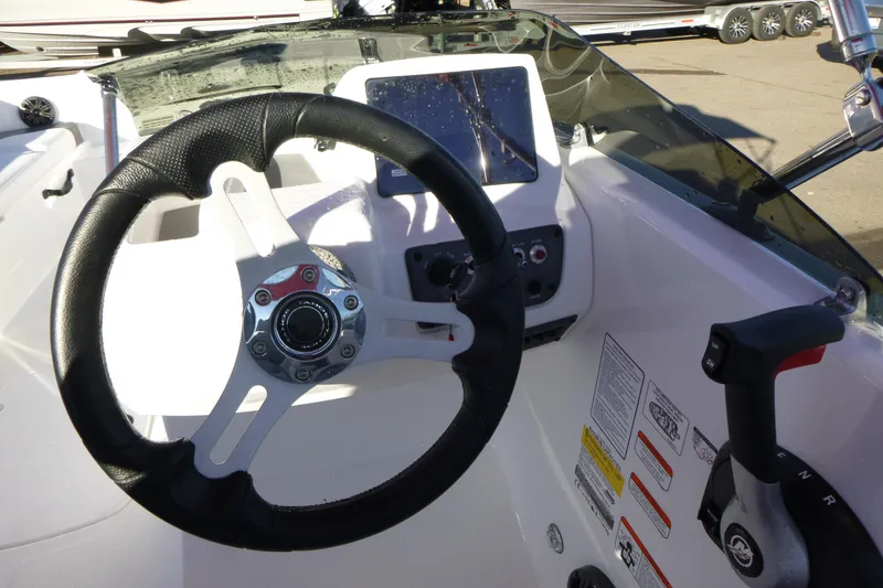 Slide: The Image of 2024 Tahoe T18 boat cockpit with steering wheel and control panel. - 12