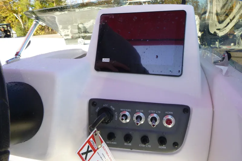 Slide: The Image of 2024 Tahoe T18 boat dashboard with control panel and display screen. - 13